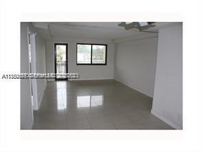 301 Golden Isles Drive, Unit 211 Hallandale Beach, FL 33009 - Photo 6 of 7 a black and white photo of a room