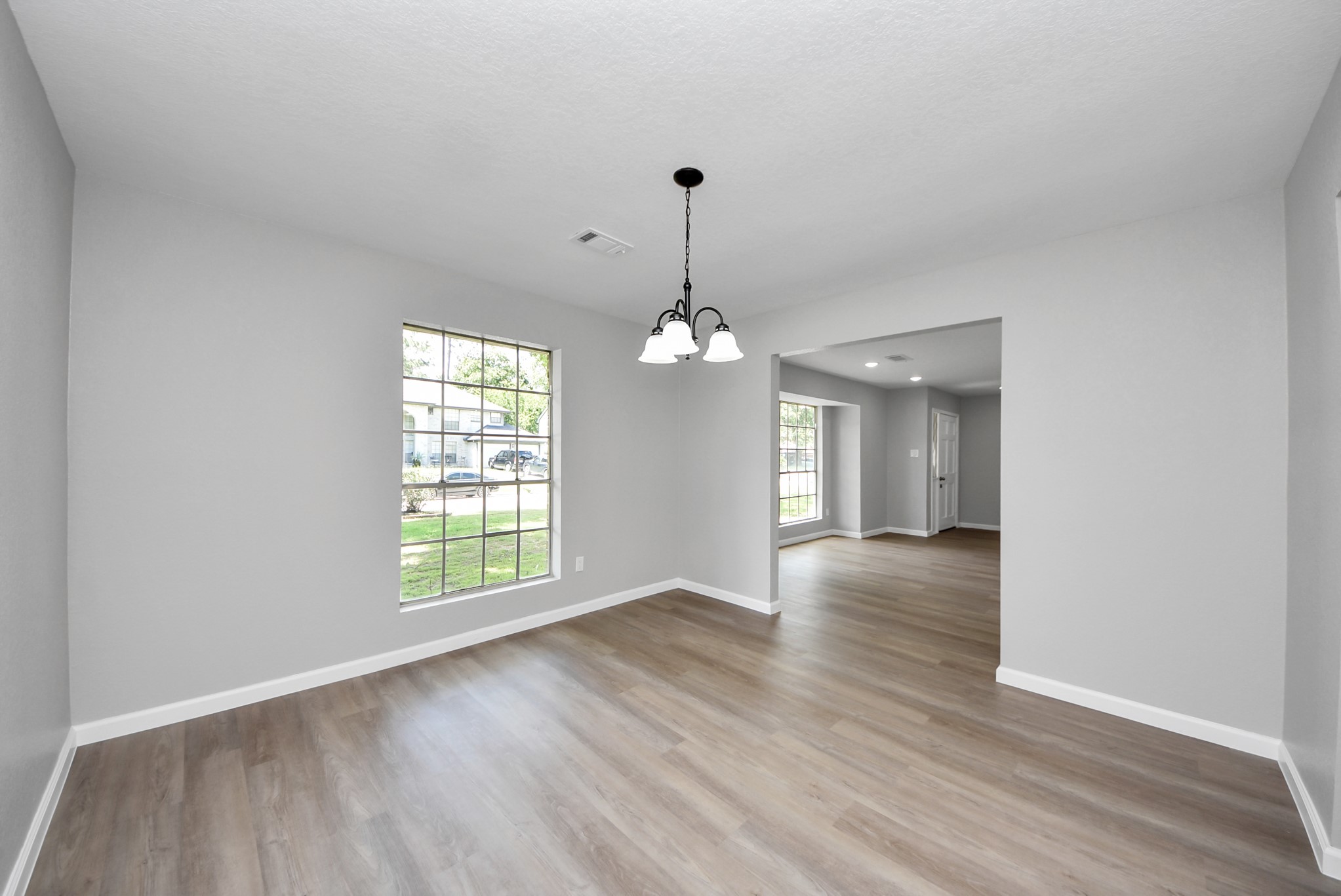2402 Rolling Glen Drive Spring, TX 77373 - Photo 17 of 38 an empty room with wooden floor and windows