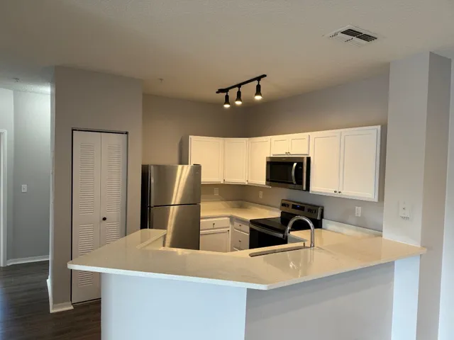 a kitchen with a refrigerator and a sink