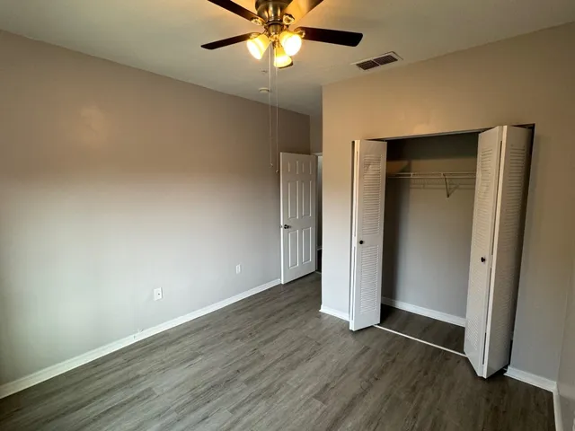 an empty room with wooden floor and door