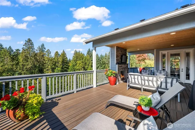 a view of a patio with couches chairs and wooden floor