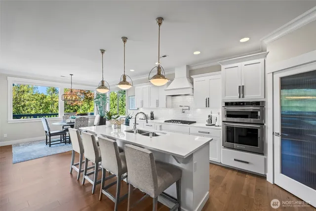a kitchen with stainless steel appliances kitchen island a large island in the center