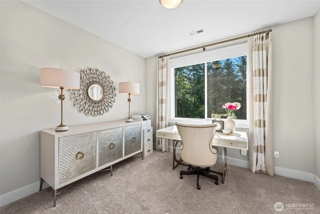 a view of a dining room with furniture and a window