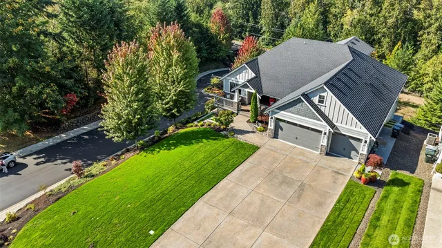a aerial view of a house next to a yard