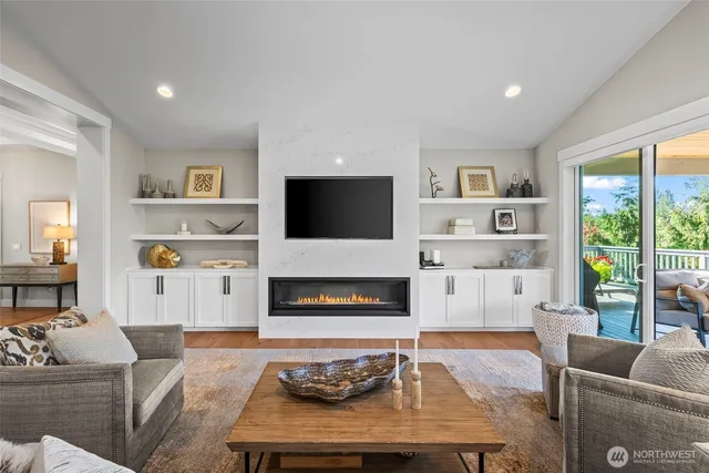 a living room with furniture flat screen tv and a fireplace