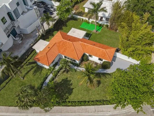 an aerial view of a house with a yard basket ball court and outdoor seating