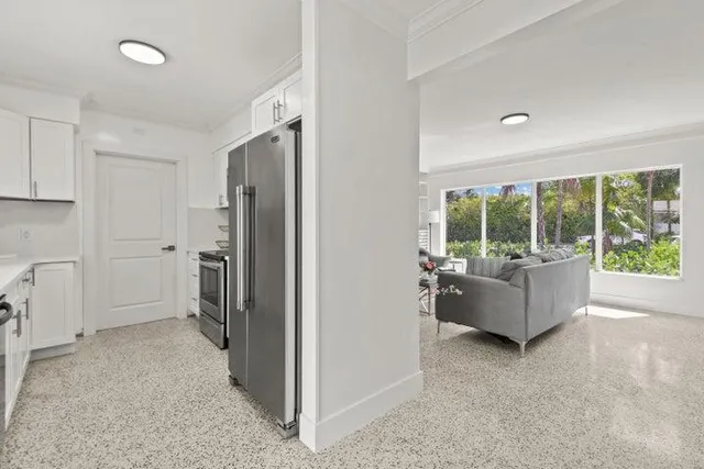 a living room with furniture and large window