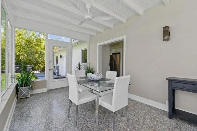a dining room with furniture and window