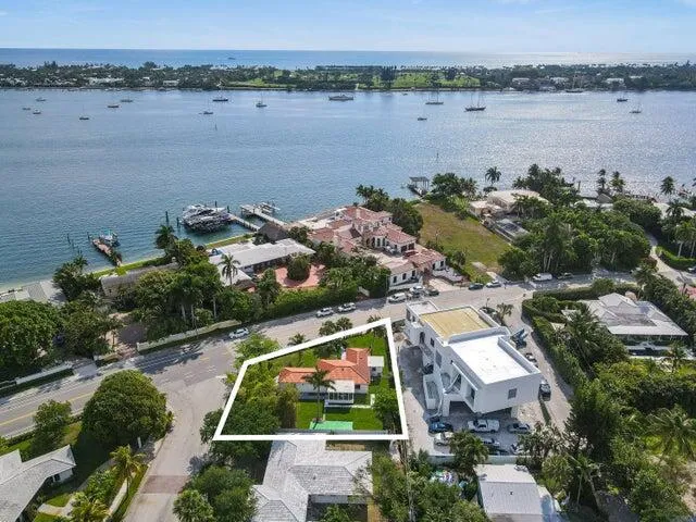 an aerial view of house with yard and ocean view