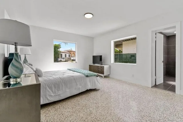 a bedroom with a bed and a flat screen tv