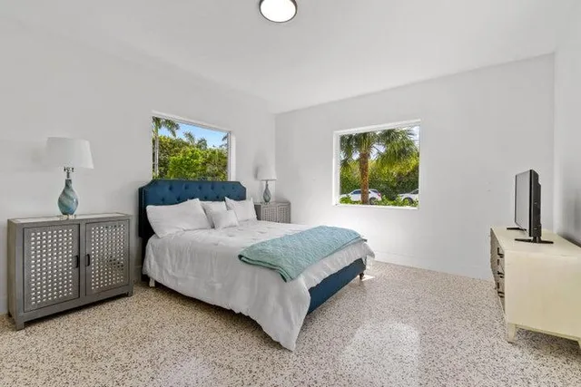 a spacious bedroom with a bed and a window