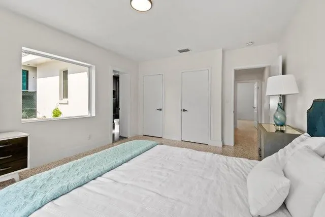 a view of a bedroom with a bed and dresser