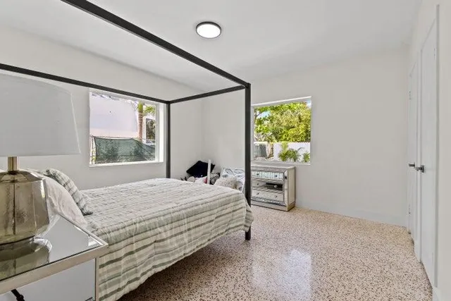 a bedroom with a bed and a window