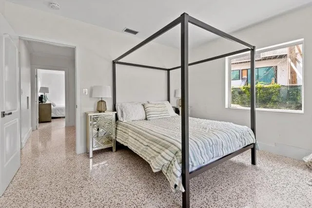 a room with a bed and a mirror