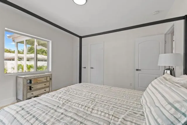 a bedroom with a bed and a window