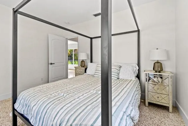 a bedroom with a bed and a window