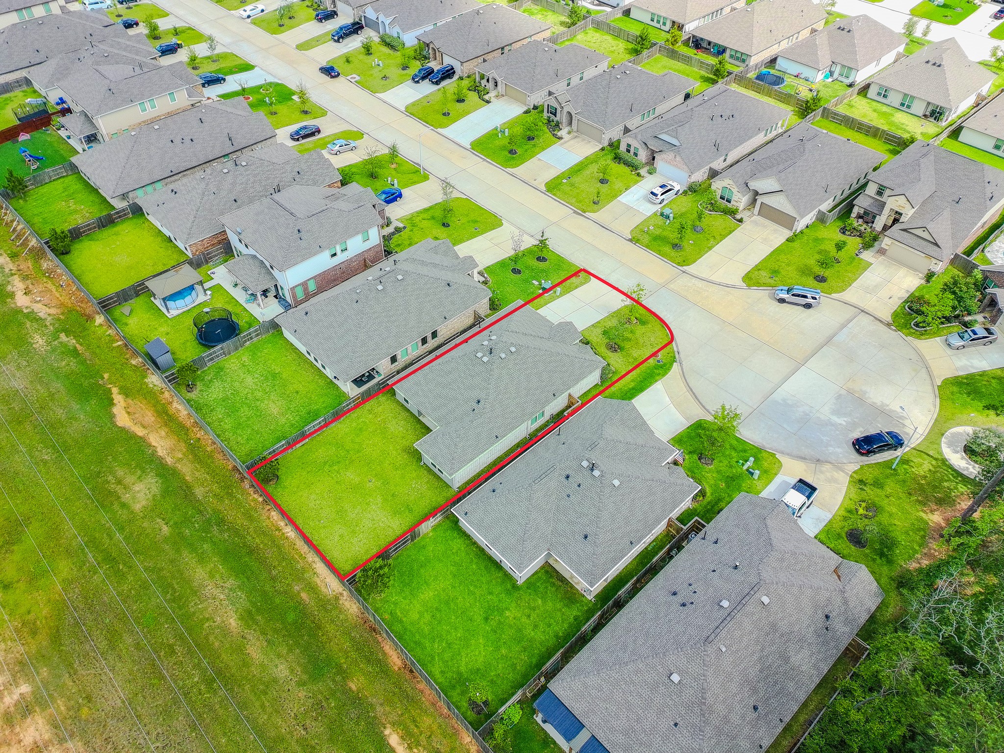 3113 Catalonion Court Conroe, TX 77301 - Photo 37 of 45 an aerial view of a tennis ground and a yard