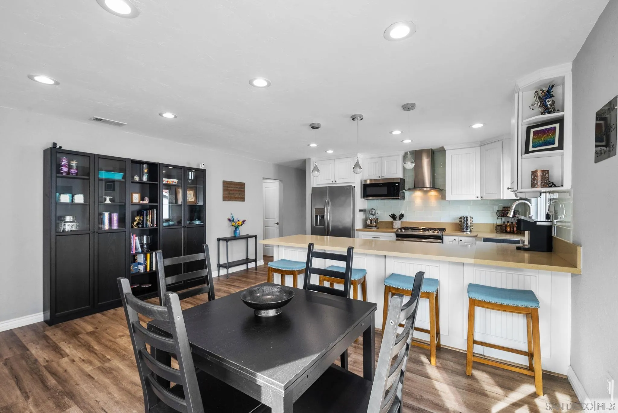 6503 Plaza Ridge Road San Diego, CA 92114 - Photo 11 of 37 a kitchen with stainless steel appliances granite countertop a stove a refrigerator a kitchen island a table and chairs