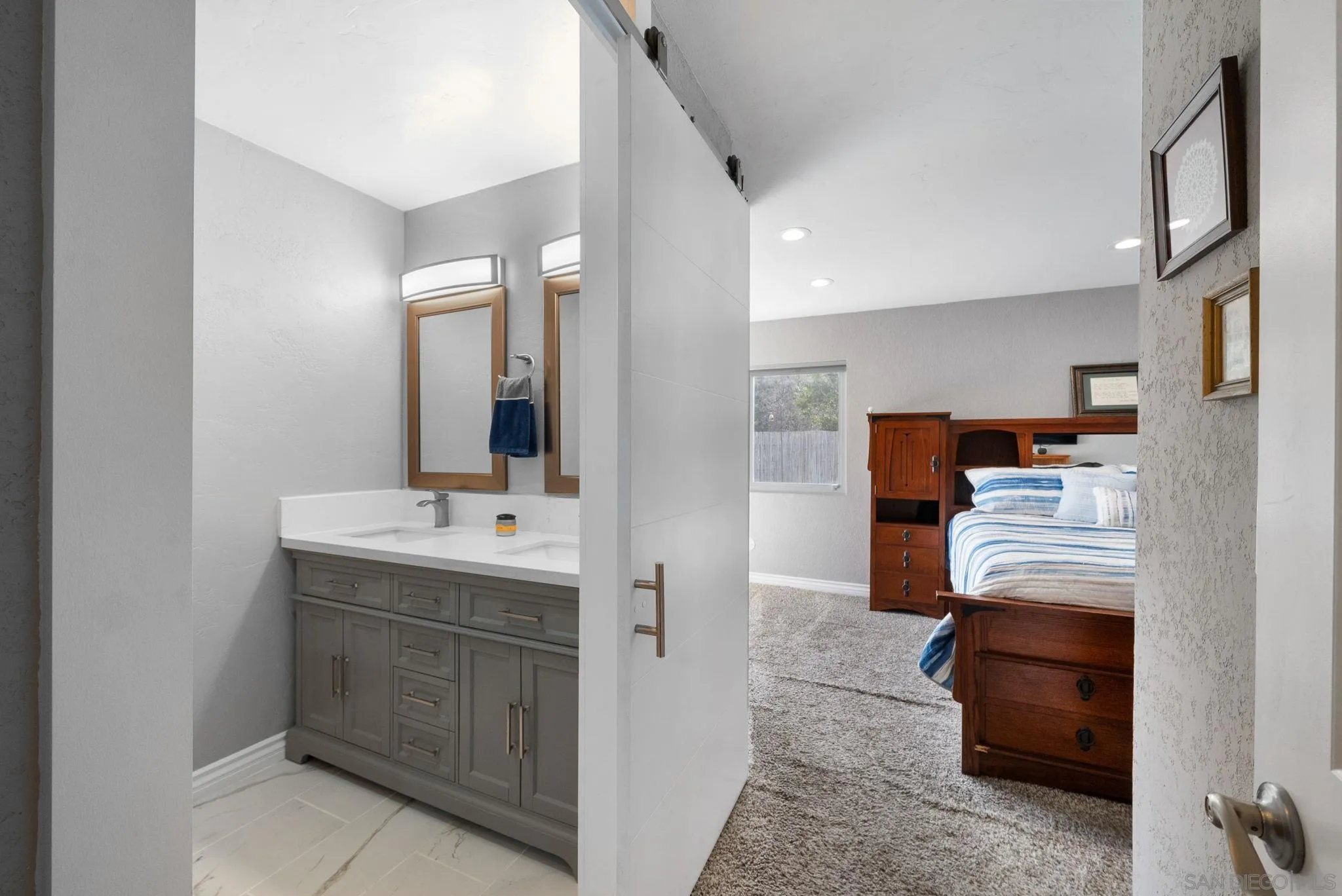 6503 Plaza Ridge Road San Diego, CA 92114 - Photo 16 of 37 a bathroom with a sink and a mirror