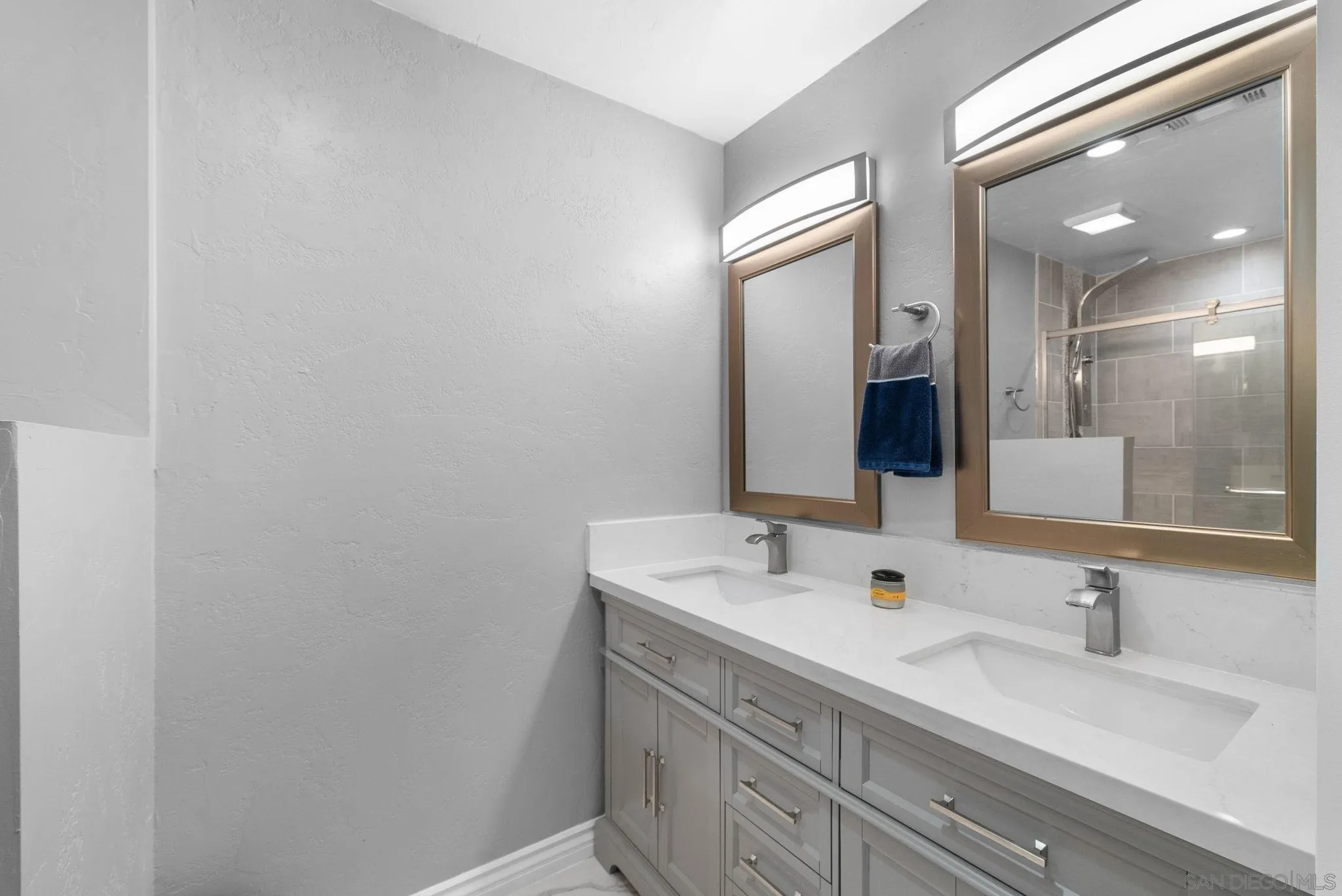 6503 Plaza Ridge Road San Diego, CA 92114 - Photo 17 of 37 a bathroom with a sink and a mirror