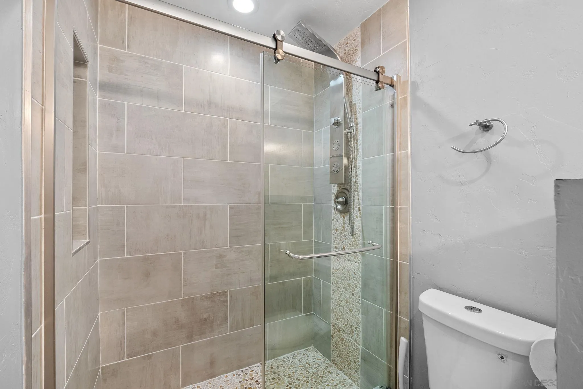 6503 Plaza Ridge Road San Diego, CA 92114 - Photo 18 of 37 a bathroom with a shower a toilet and sink