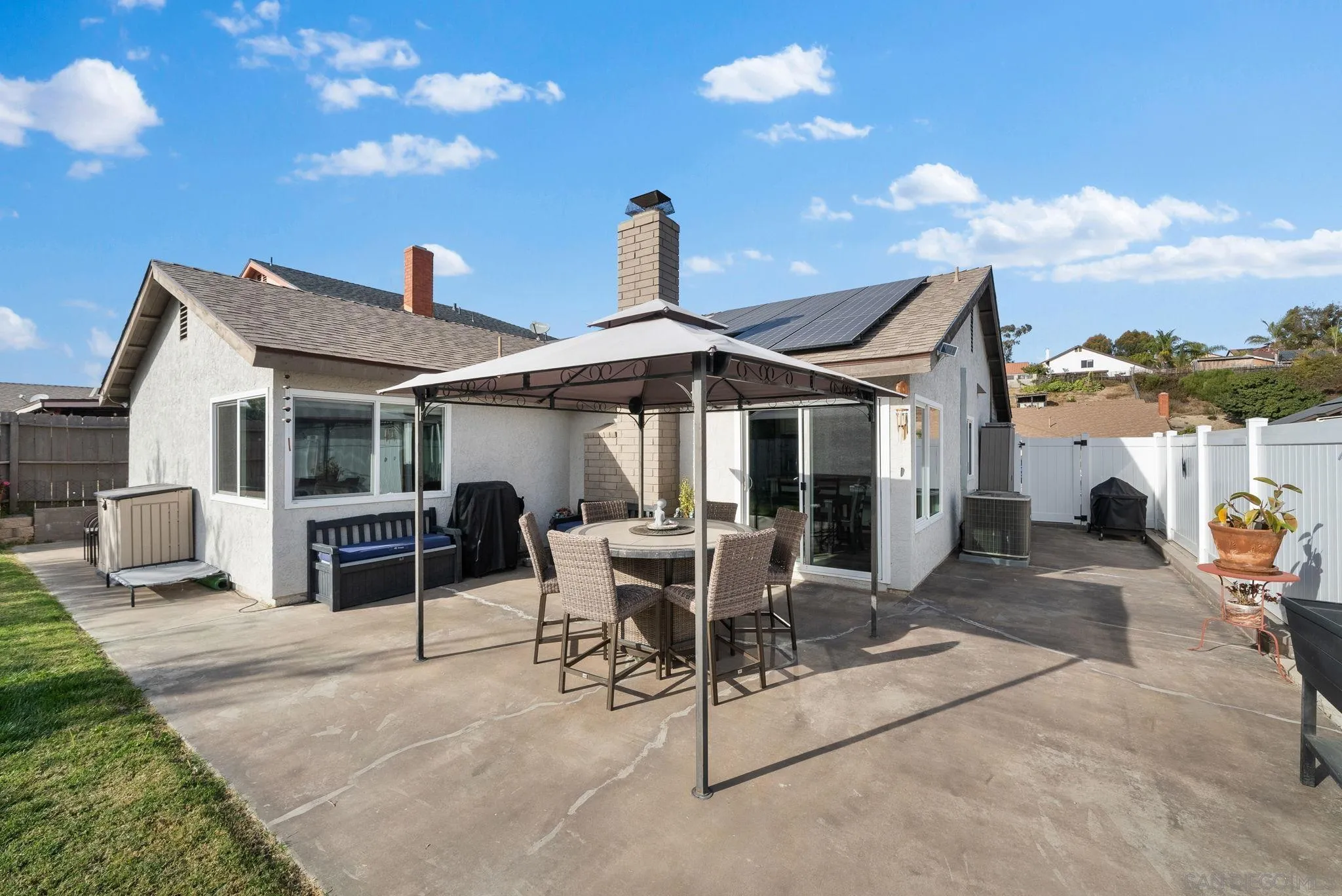 6503 Plaza Ridge Road San Diego, CA 92114 - Photo 24 of 37 a patio with a table and chairs and potted plants
