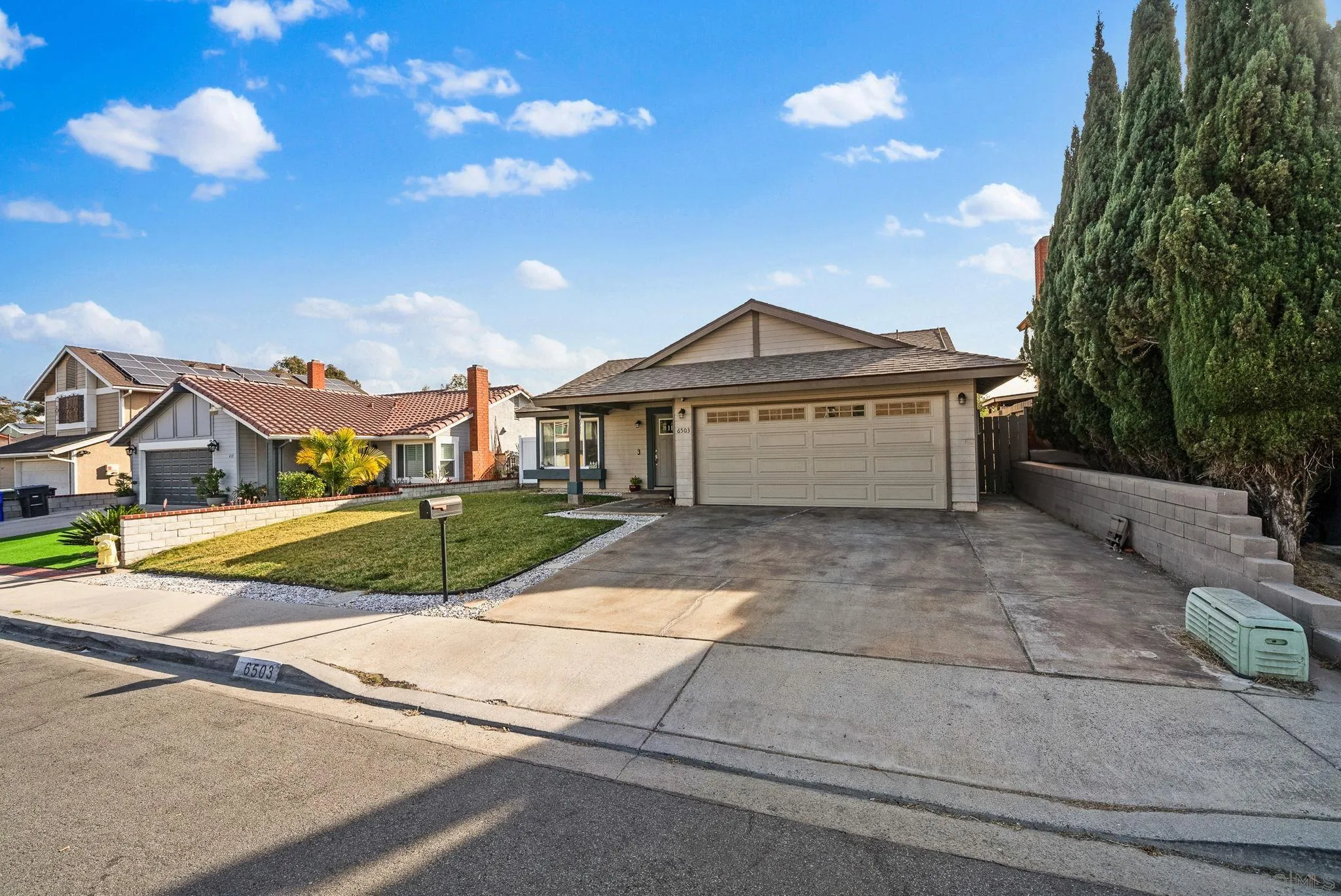 6503 Plaza Ridge Road San Diego, CA 92114 - Photo 3 of 37 a front view of a house with a yard and garage
