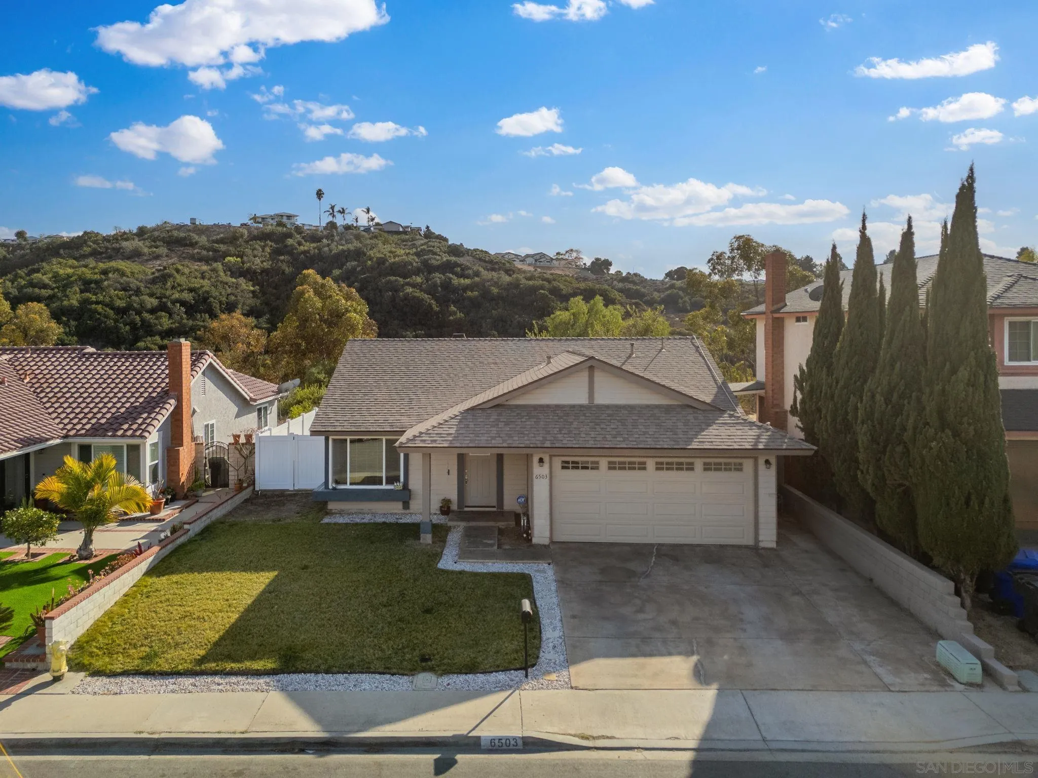 6503 Plaza Ridge Road San Diego, CA 92114 - Photo 36 of 37 a front view of a house with garden