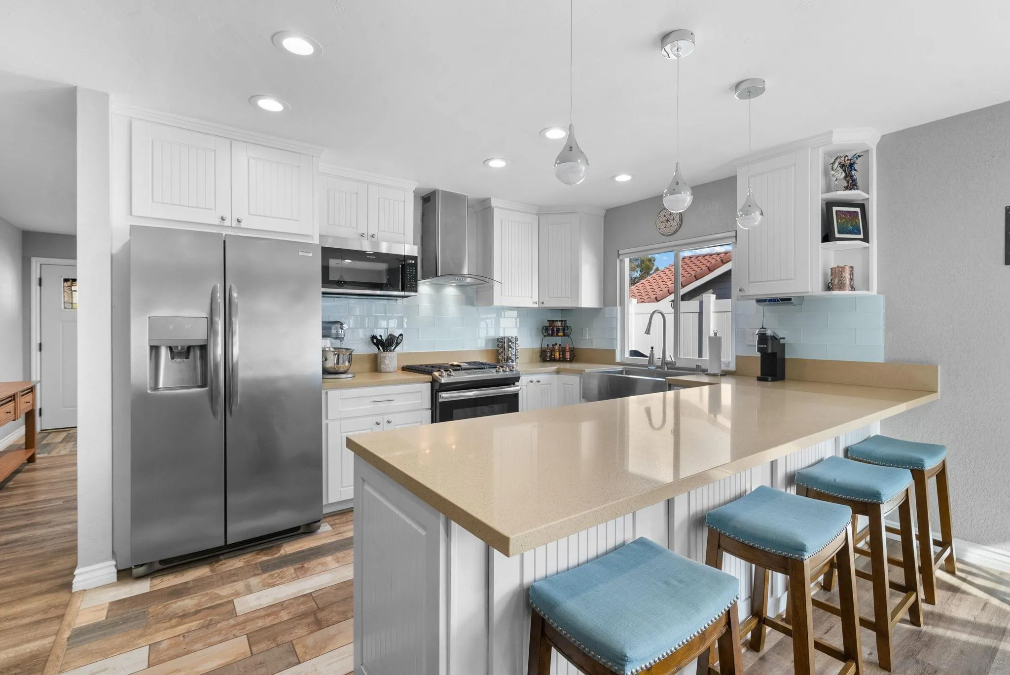 6503 Plaza Ridge Road San Diego, CA 92114 - Photo 7 of 37 a kitchen with stainless steel appliances granite countertop a refrigerator a stove a sink a dining table and chairs