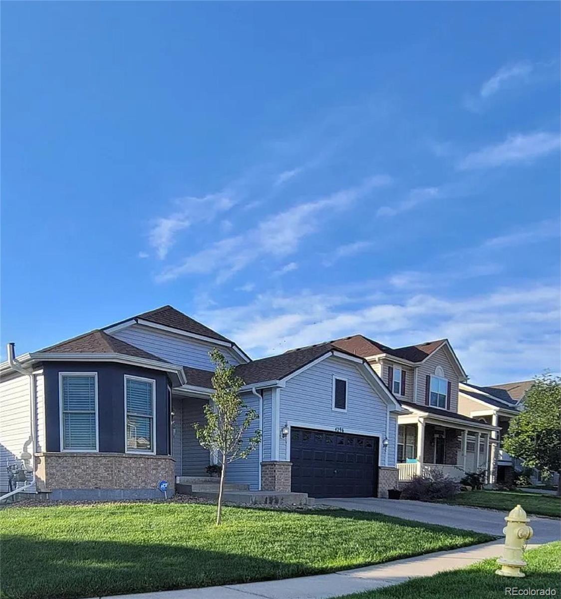 4296 Clover Lane Brighton, CO 80601 - Photo 2 of 35 a front view of a house with a yard