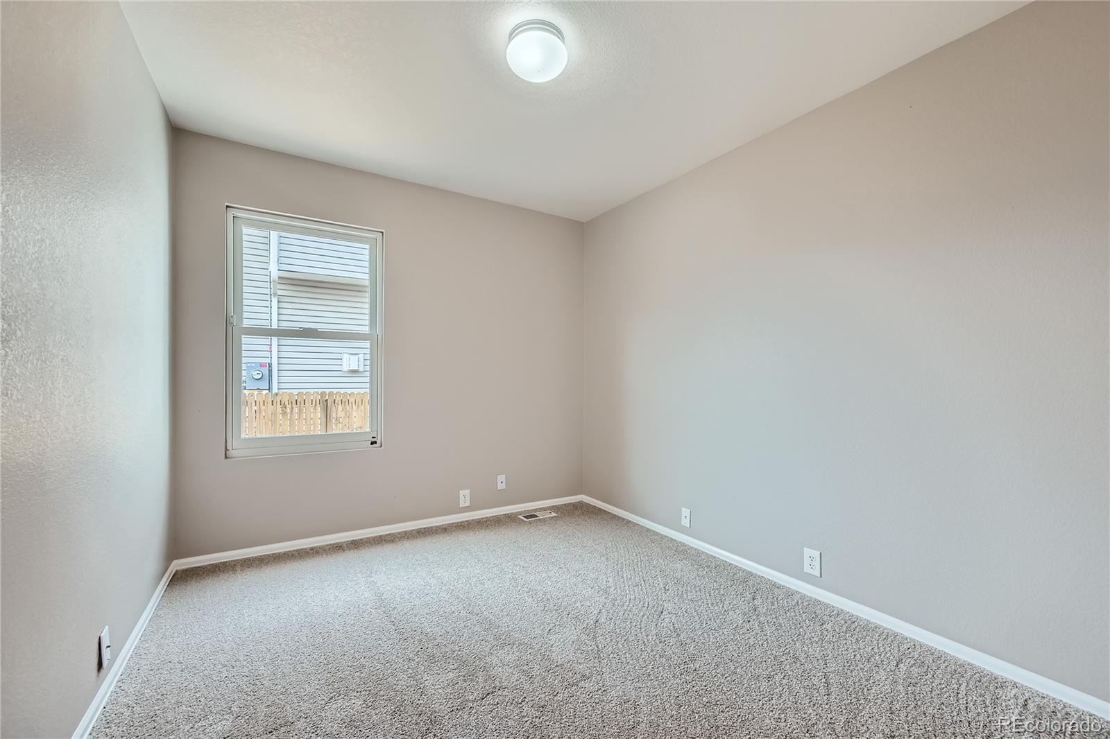 4296 Clover Lane Brighton, CO 80601 - Photo 23 of 35 an empty room with a window