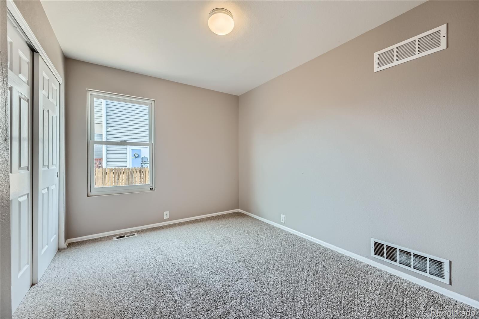 4296 Clover Lane Brighton, CO 80601 - Photo 26 of 35 a view of an empty room with a window