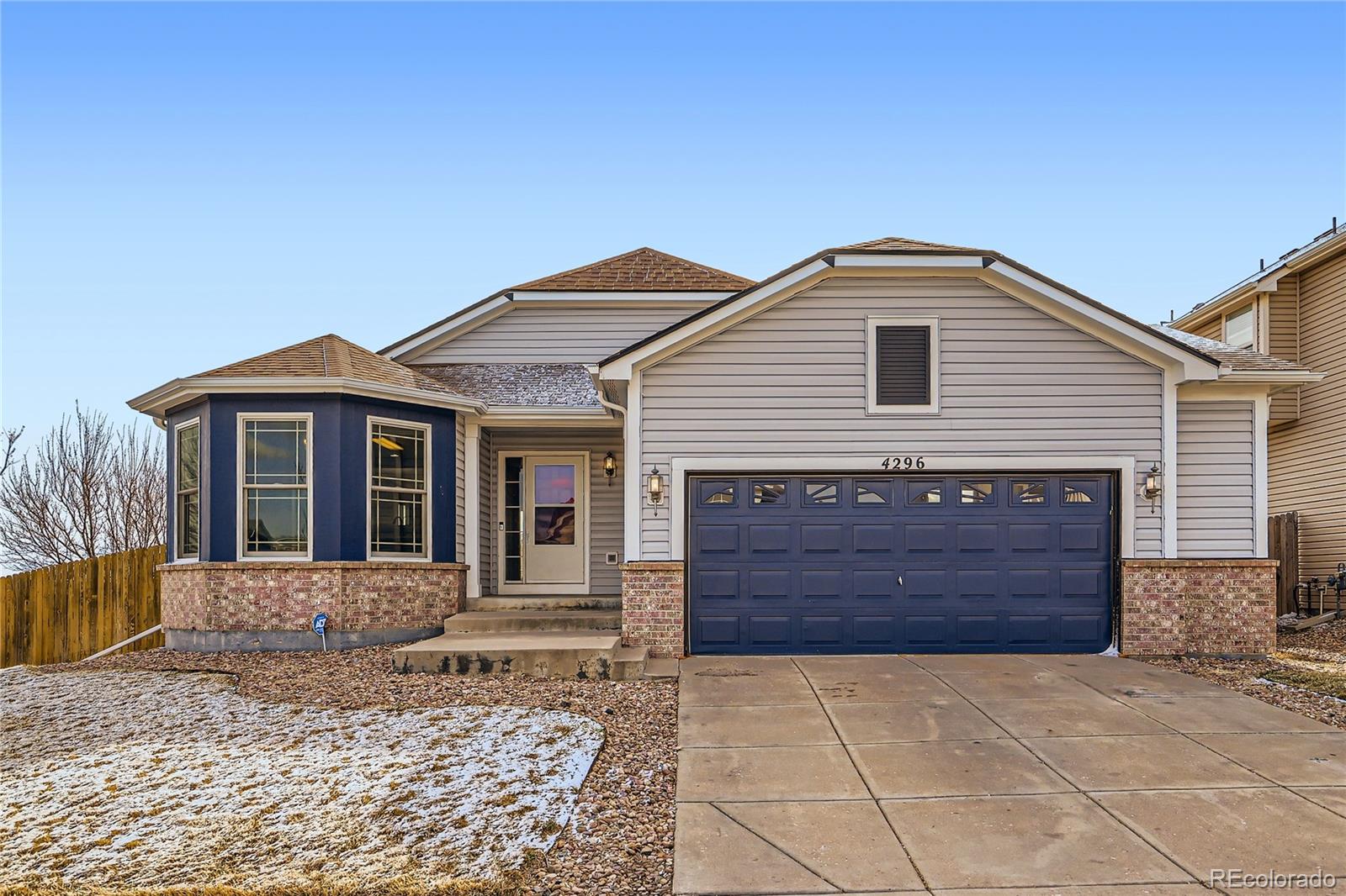 4296 Clover Lane Brighton, CO 80601 - Photo 3 of 35 a front view of a house with a yard
