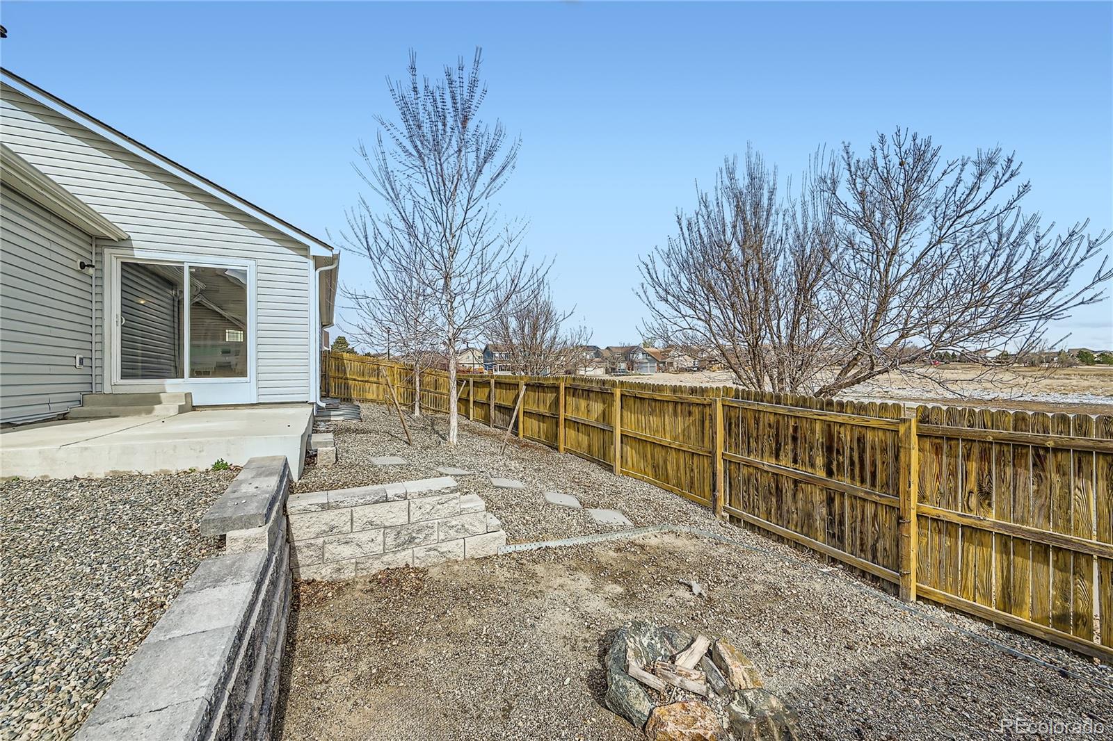 4296 Clover Lane Brighton, CO 80601 - Photo 32 of 35 a view of a backyard with wooden fence