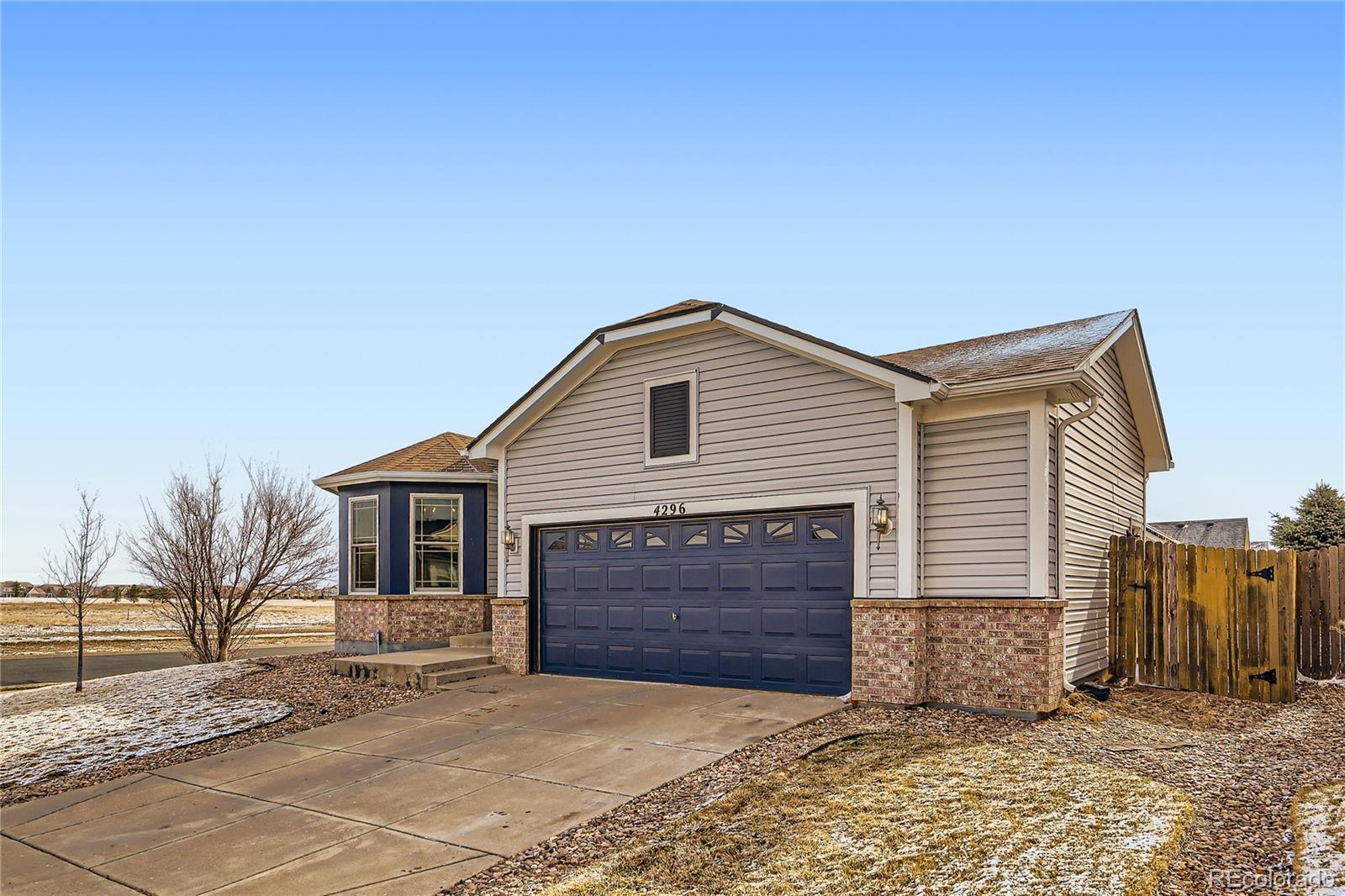 4296 Clover Lane Brighton, CO 80601 - Photo 4 of 35 a front view of a house with a yard