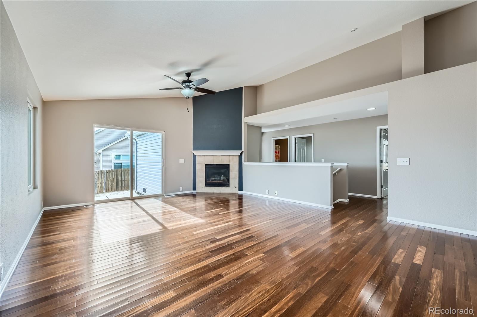 4296 Clover Lane Brighton, CO 80601 - Photo 7 of 35 a view of an empty room with window and wooden floor