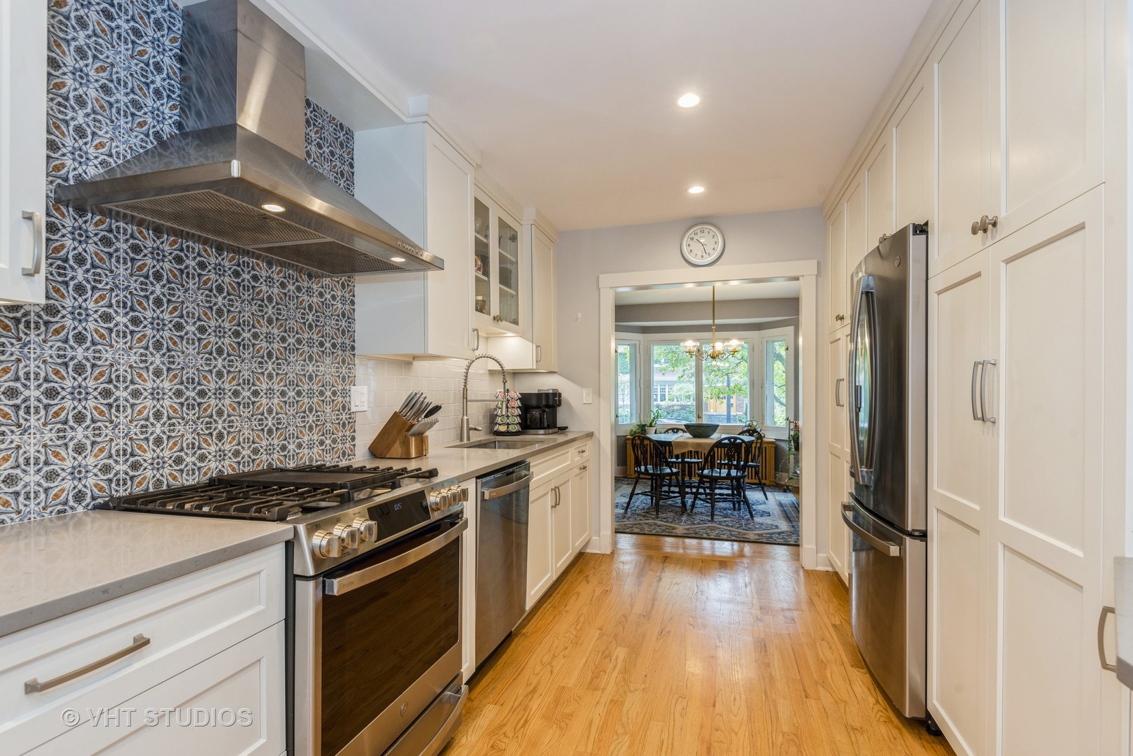 2415 Harrison Street Evanston, IL 60201 - Photo 12 of 42 a kitchen with granite countertop a stove and a wooden floors