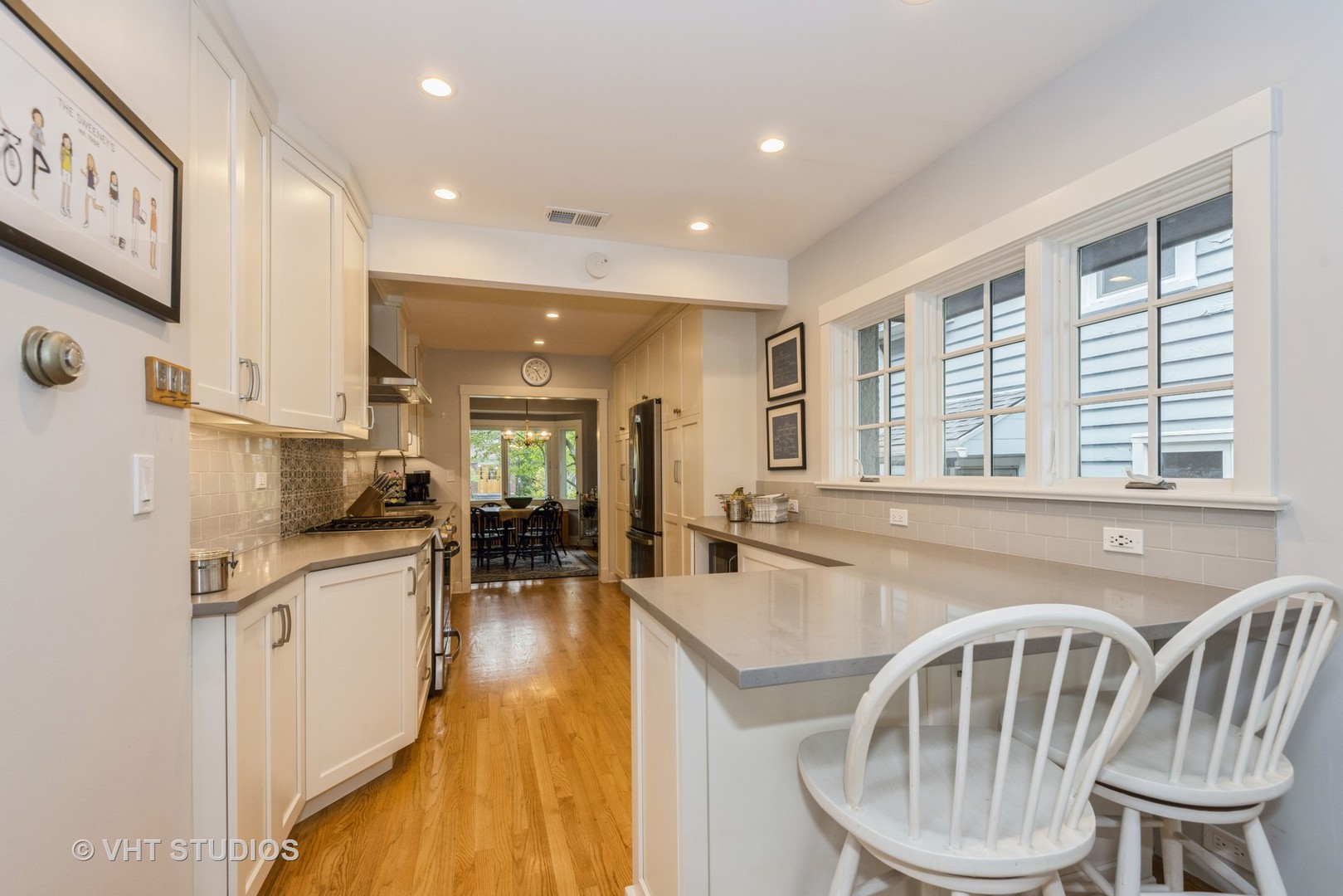 2415 Harrison Street Evanston, IL 60201 - Photo 14 of 42 a dining room with furniture a window and wooden floor