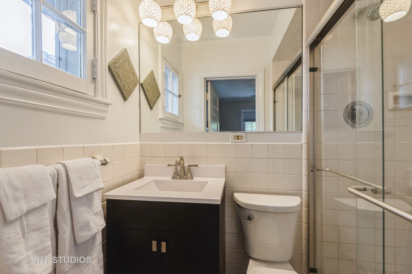 2415 Harrison Street Evanston, IL 60201 - Photo 23 of 42 a bathroom with a sink a toilet and shower