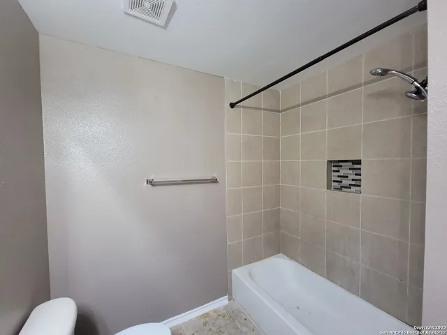 a bathroom with a tub and shower