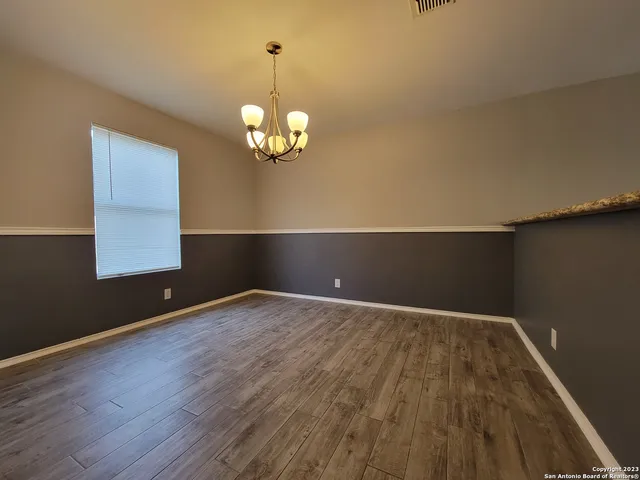 a view of wooden floor and windows in a room