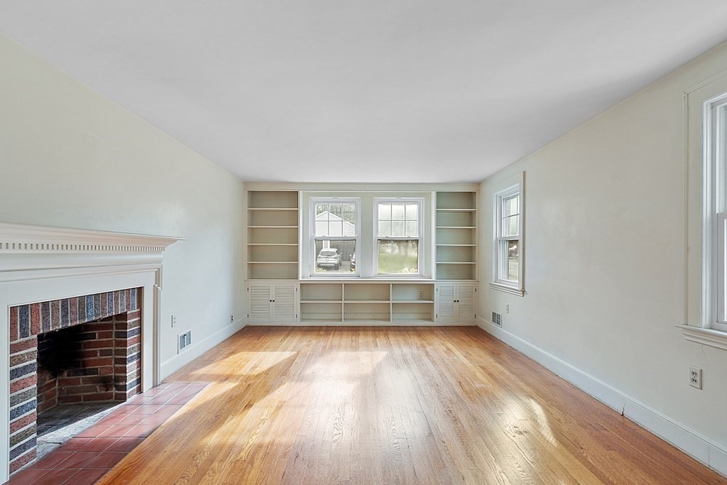 18 Beaver Park Danvers, MA 01923 - Photo 14 of 42 a view of empty room with wooden floor and fireplace