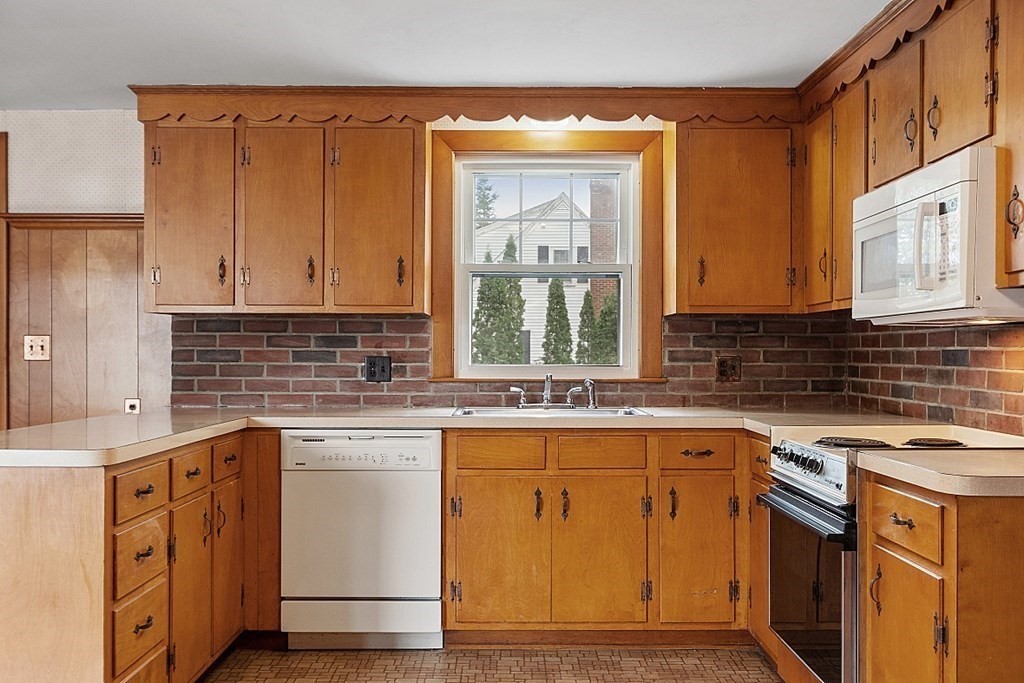 18 Beaver Park Danvers, MA 01923 - Photo 16 of 42 a kitchen with stainless steel appliances granite countertop a sink stove and cabinets