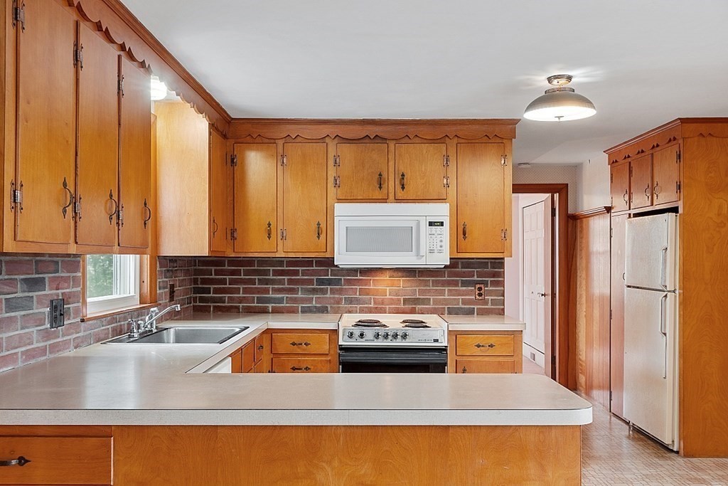18 Beaver Park Danvers, MA 01923 - Photo 17 of 42 a kitchen with stainless steel appliances granite countertop a sink stove and refrigerator
