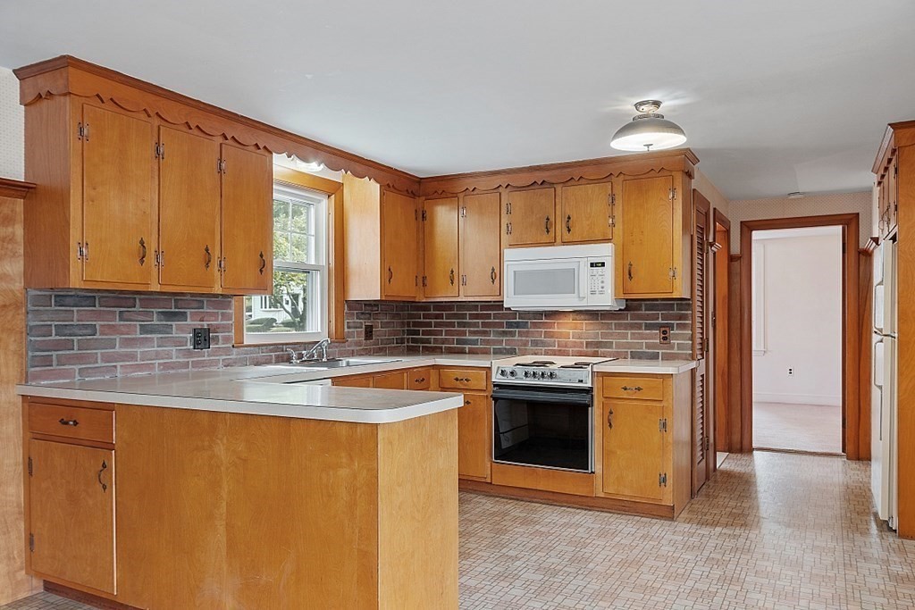18 Beaver Park Danvers, MA 01923 - Photo 18 of 42 a kitchen with stainless steel appliances granite countertop a sink stove and refrigerator
