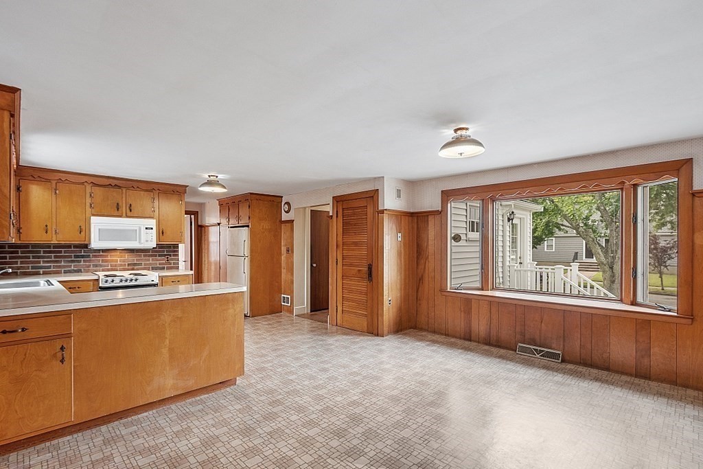 18 Beaver Park Danvers, MA 01923 - Photo 20 of 42 a view of a kitchen with a sink cabinet a fireplace and windows