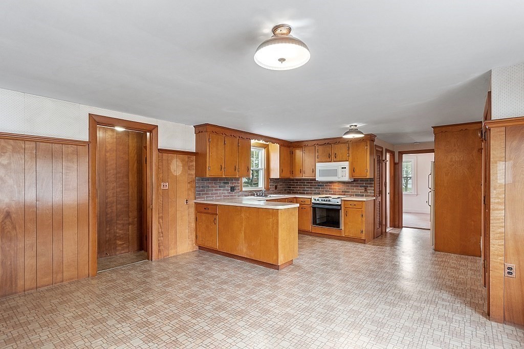 18 Beaver Park Danvers, MA 01923 - Photo 21 of 42 a kitchen with stainless steel appliances granite countertop a refrigerator a sink dishwasher and a stove