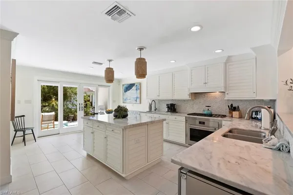 a kitchen with a stove a sink and a refrigerator