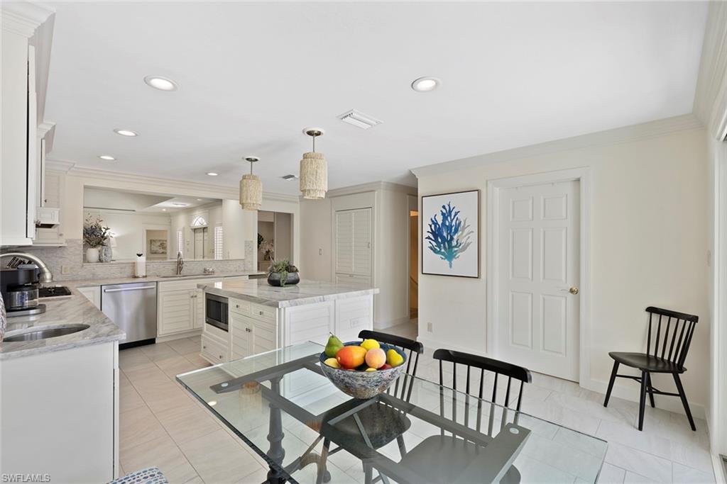 2700 Treasure Lane Naples, FL 34102 - Photo 16 of 44 a living room with dining room and wooden floor