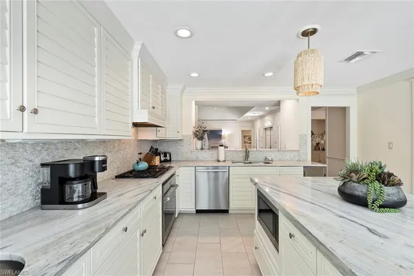 a kitchen with a sink stove and cabinets